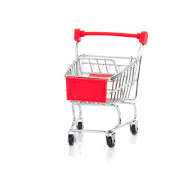 Miniature shopping cart and basket on white