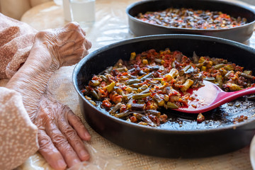 Old woman enjoying some homemade okra