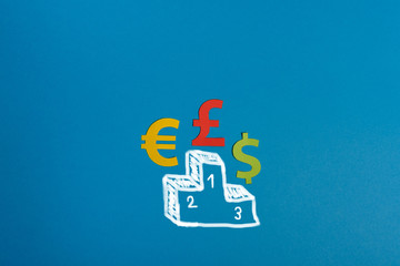 Paper symbols of euro, dollar and british pound currency on podium, blue background. View from above with copy space. Minimalistic simple concept.