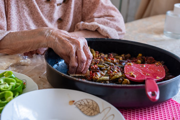 Old woman enjoying some homemade okra