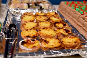 Freshly baked Portuguese custard tarts on tray