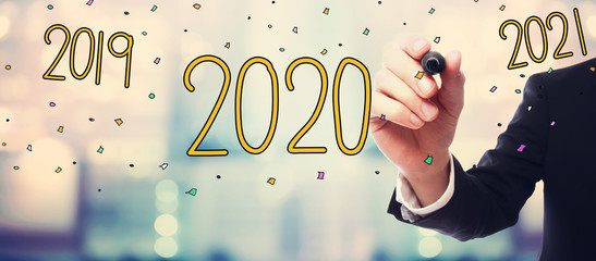 2020 concept with businessman on blurred abstract background