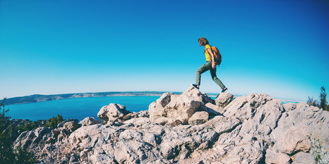 Girl on the background of the sea and mountains.