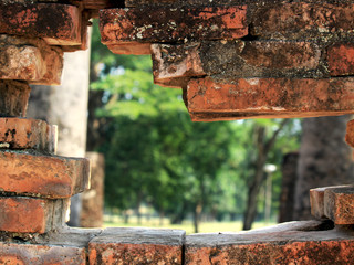 Hole in old wall brick of archaeological site at wat Si Chum temple, popular tourist attractions and famous landmarks in Sukhothai historical park, Sukhothai, Thailand. UNESCO world heritage city