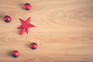 Christmas background - flat lay of red christmas balls over wooden background. Copy space.