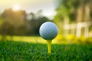 Golf ball on tee in beautiful golf course