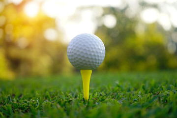 Golf ball on tee in beautiful golf course