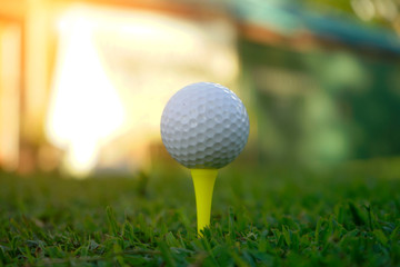 Golf ball on tee in beautiful golf course