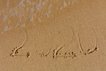 New year 2020. Inscription on a sandy beach. Tropical celebration concept
