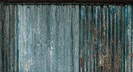 Rusty corrugated galvanized steel wall or iron metal sheet surface for texture and background.