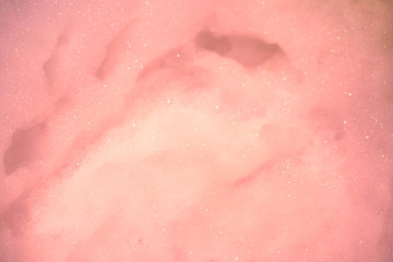 Pink soap bubbles on the water with beautiful bokeh bubbles.