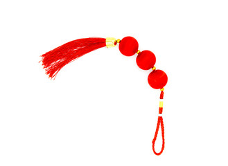 Chinese red knot with tassel, top view photo. Asian holiday symbol. Red silk knot isolated. Chinese New Year decoration