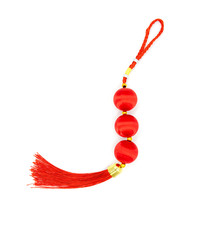Red knot with tassel, top view photo. Chinese holiday symbol. Red silk knot isolated. Chinese New Year decoration