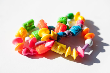 a colorful child's necklace on white background