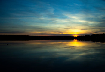 Beautiful sunset reflected in the lake. Scenic landscape