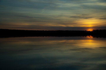 Beautiful sunset reflected in the lake. Scenic landscape