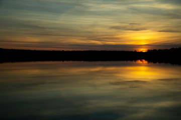 Beautiful sunset reflected in the lake. Scenic landscape
