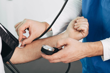 doctor measures blood pressure to patient, close-up. Check a blood pressure