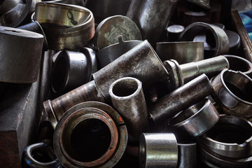 close up pile of old metal machine parts in the factory