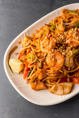Stir fry Pad Thai with shrimp, squid, tofu, and peanuts. 