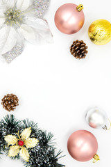 Fototapeta na wymiar Pink and golden Christmas ornament on white. Winter holiday vertical photo background with fir tree baubles.
