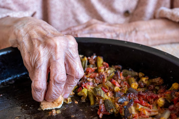 Old woman enjoying some homemade okra
