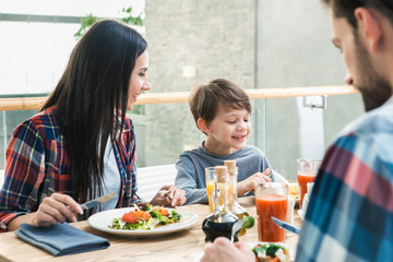 Family Sitting Together in the Restaurant Lunch Concept
