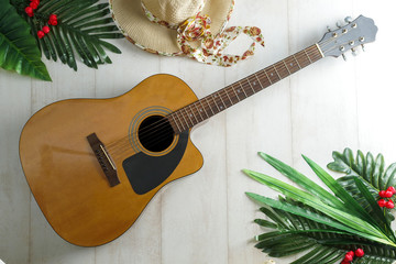 Camping or adventure trip scenery concept. Backpack, guitar, boots, belt, thermos and camera on wooden background captured from above (flat lay). Layout with free text (copy) space.