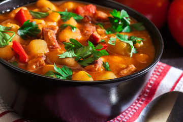 White bean soup with potatoes, tomatoes, paprika, and bacon