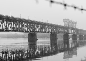  Bridge in the morning fog. Iron bridge over the river in mystic fog.