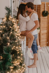 Beautiful couple in love celebreting Christmas. Kitchen breakfast - Image