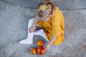 little girl with pumpkin