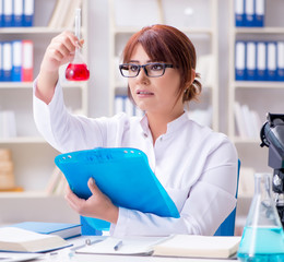 Female scientist researcher conducting an experiment in a labora