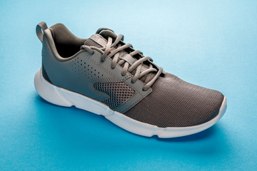 gray sports sneakers isolated on a blue background. Sport shoes