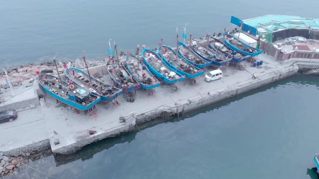 boats being repaired : wooden fisherman boats during morning with fog Dalian, China, 19-6-19
