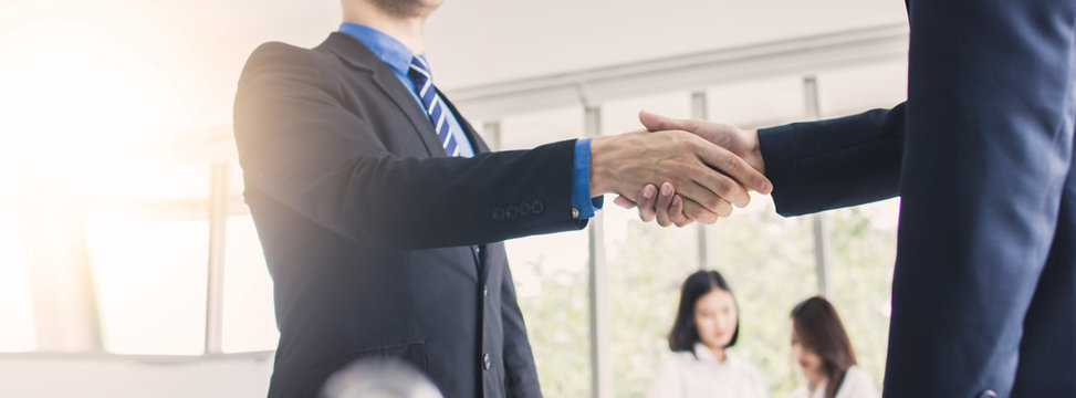 successful negotiate and handshake concept, two businessman shake hand with parthner to celebration partnership and teamwork, business deal