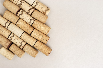 Wine corks on paper background with copy space. Close up used wooden stoppers. Concept for white wine.