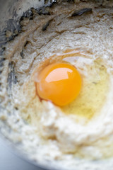 Broken egg and flour in a bowl. Food preparation concept