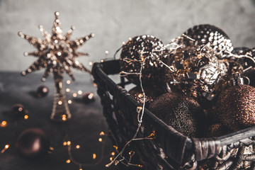 Wicker basket with Christmas toys and holiday decorations lights, copy space, new year decoration