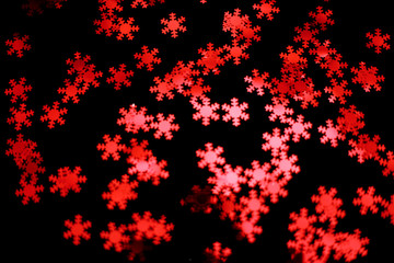red snowflake glitter sparkle isolated on black background