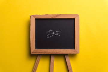 Black Board with yellow background, diet or healthy eating concept typography.