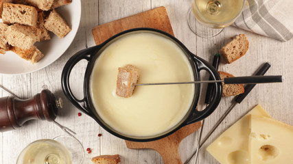 cheese fondue with wine and bread, top view