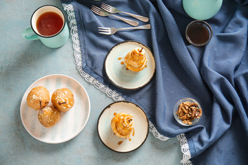 Tasty cooked pears with cup of tea on color background