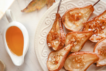 Tasty cooked pears with honey on table