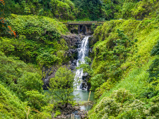 Fototapeta na wymiar Maui, Hawaii Hana Highway - Wailua Iki Falls (Wailuaiki). Road to Hana connects Kahului to the town of Hana Over 59 bridges, 620 curves, tropical rainforest