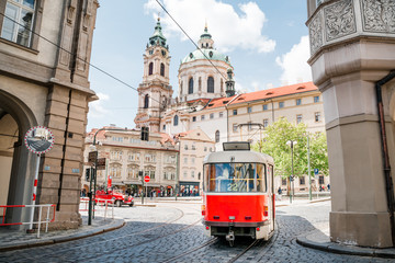 Red tram on the street of old Prague - obrazy, fototapety, plakaty