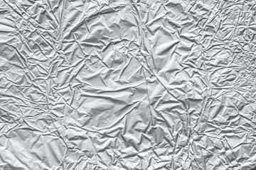 Shiny metal silver gray foil crumpled texture background