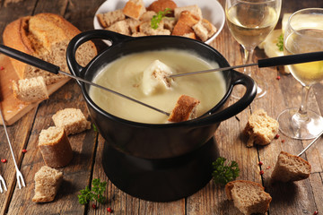 cheese fondue with wine and bread, top view