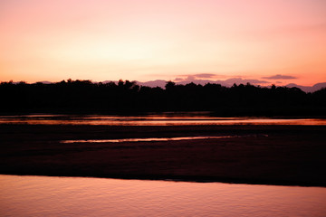 silhouette river in evening and sunset with mountain background