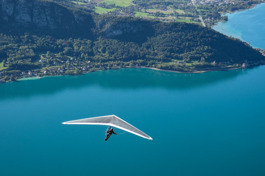 Hang glider flying over a lake, Annecy, France
